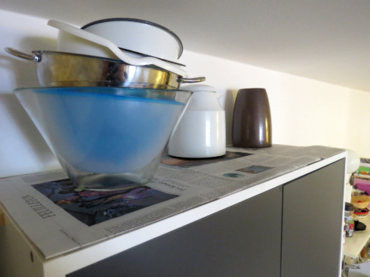 Top of cupboard with newspaper on top 